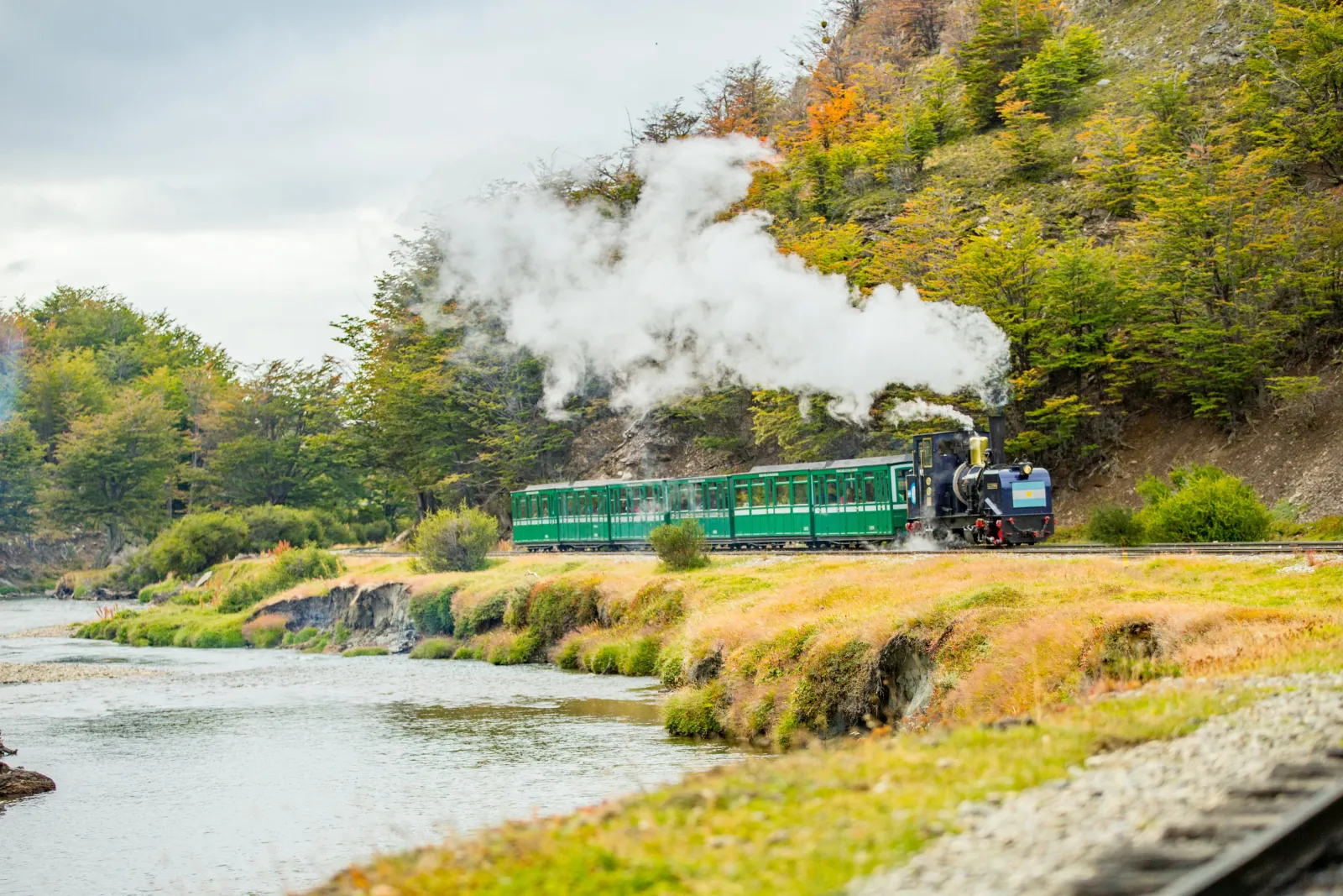 End of the World Train steaming beside the Pipo River in autumn